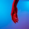 persons left hand on blue surface